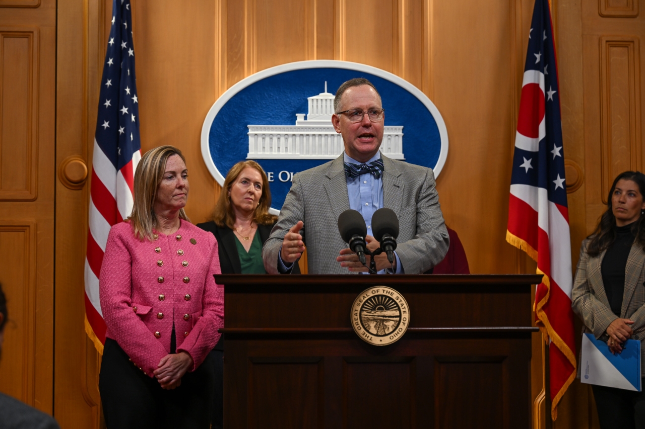 Senator Blessing speaking at news conference next to Representative Baker.